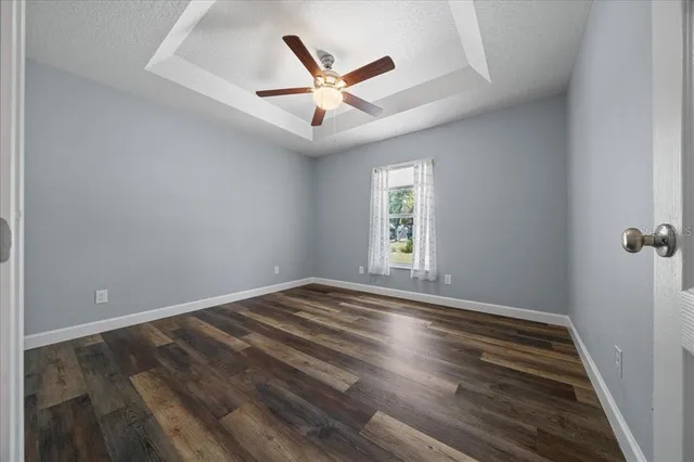 a view of empty room with ceiling fan