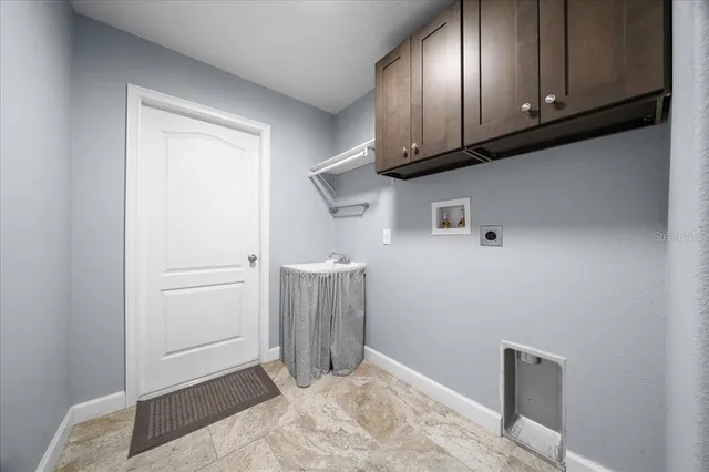 a view of a hallway with bathroom and wooden floor