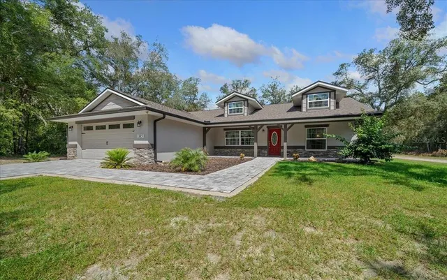 a front view of a house with a yard and porch