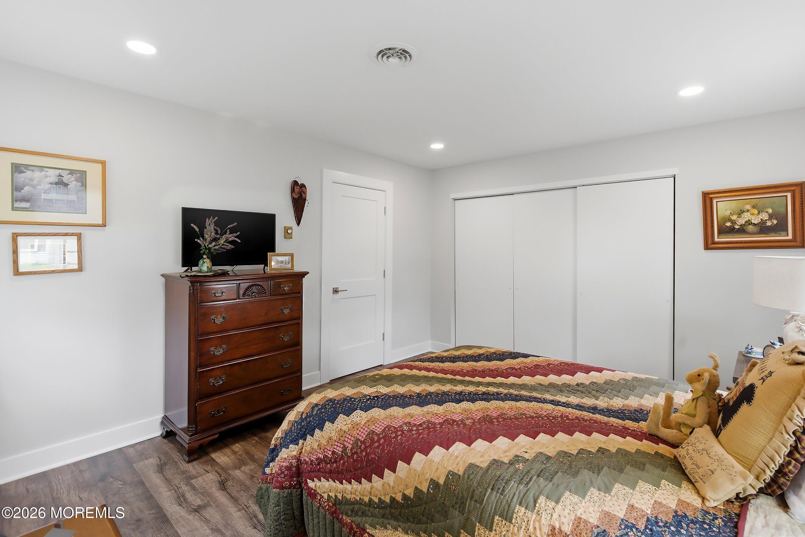 2 Berry Hill Road, Unit 72 Whiting, NJ 08759 - Photo 15 of 43 a bedroom with a bed and a flat screen tv