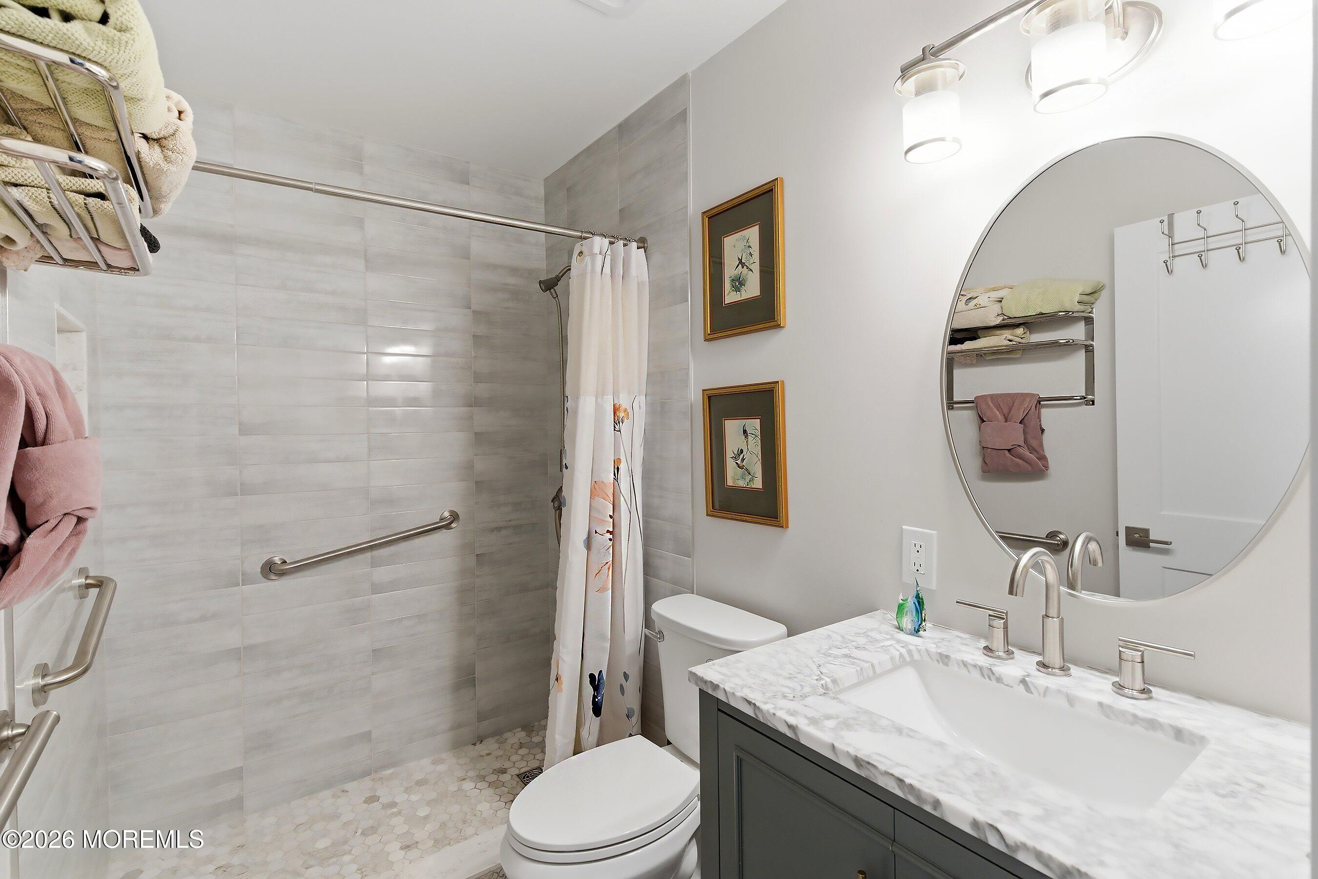 2 Berry Hill Road, Unit 72 Whiting, NJ 08759 - Photo 16 of 43 a bathroom with a granite countertop sink toilet and shower