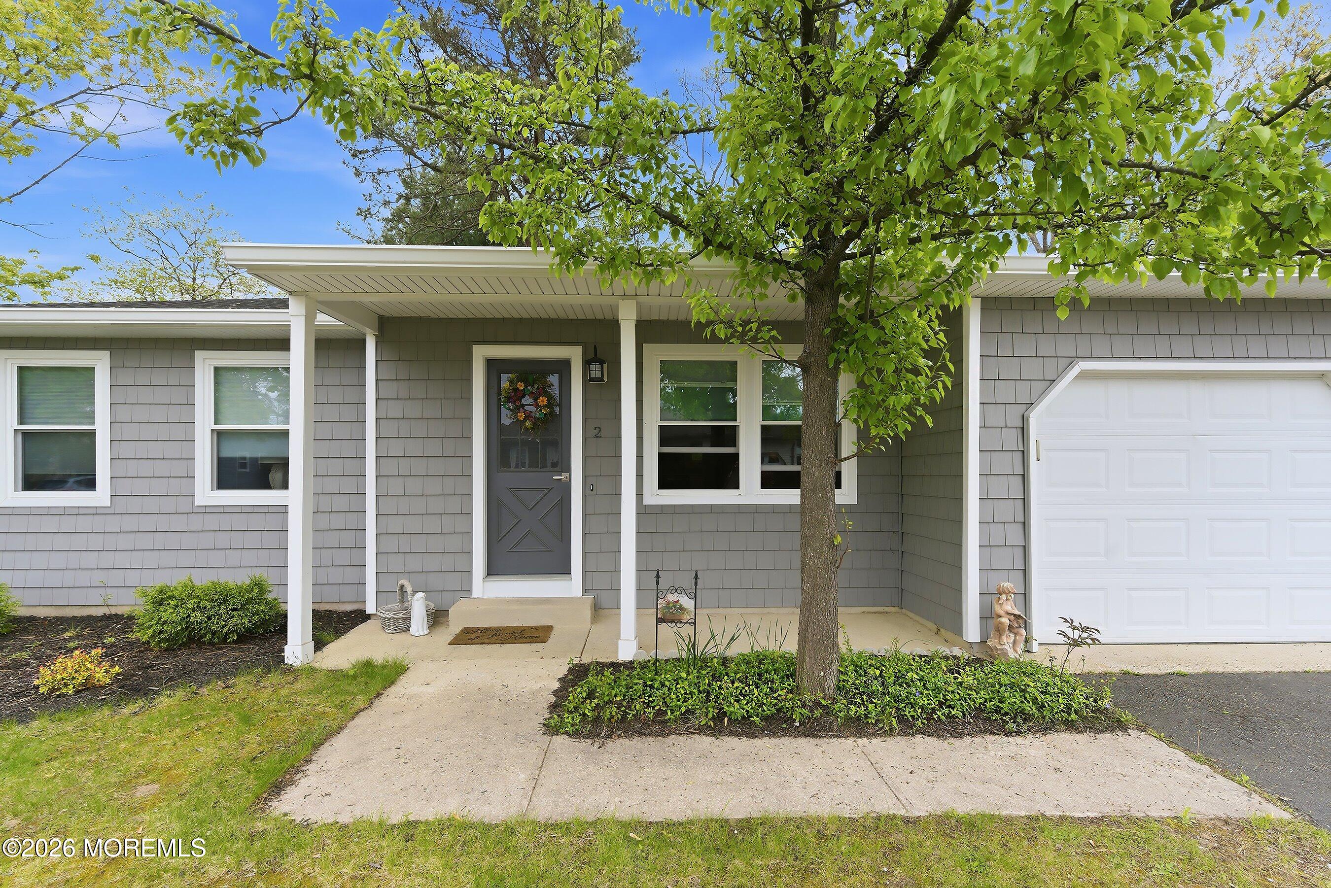 2 Berry Hill Road, Unit 72 Whiting, NJ 08759 - Photo 4 of 43 a front view of a house with garden
