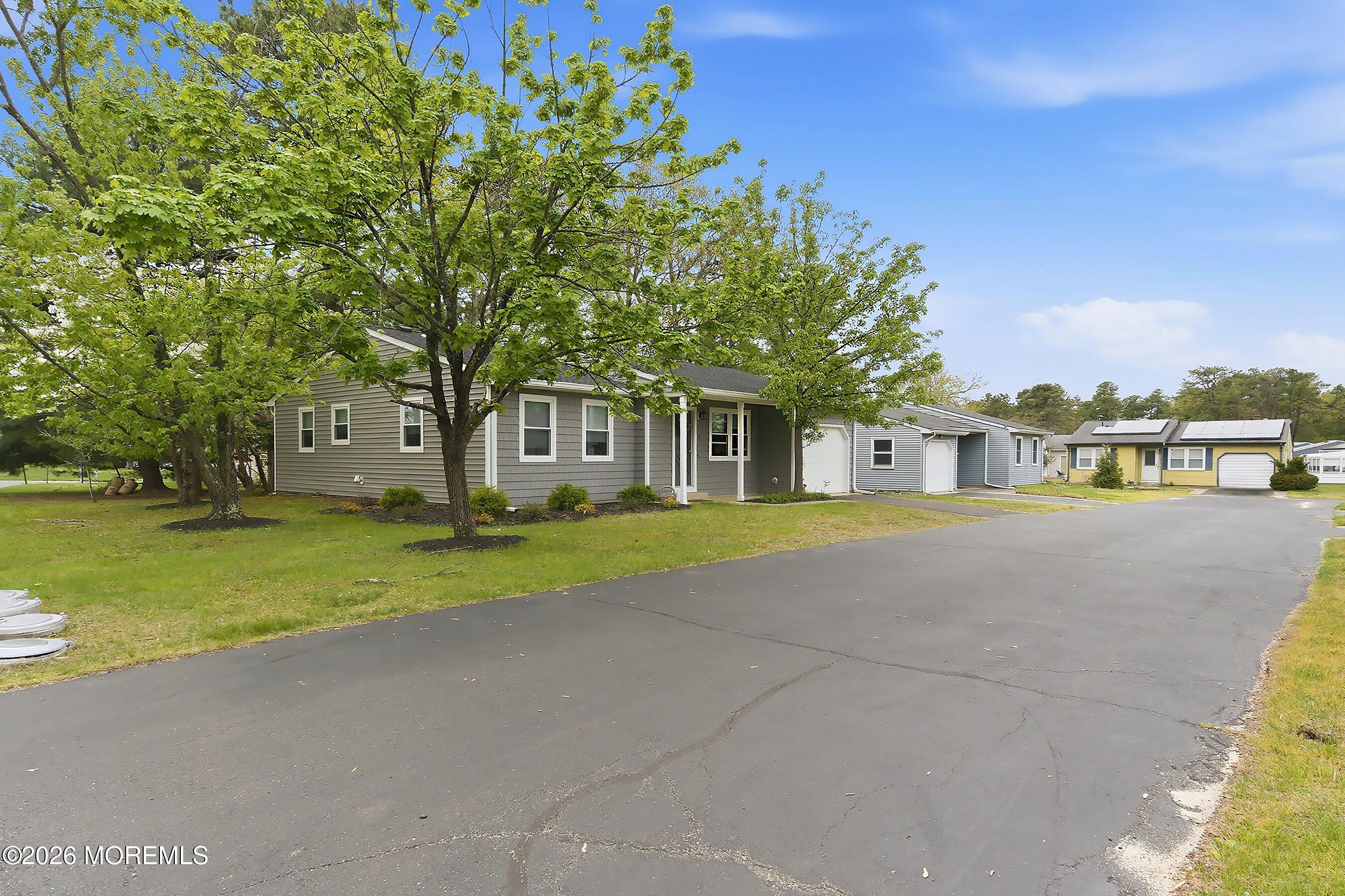 2 Berry Hill Road, Unit 72 Whiting, NJ 08759 - Photo 5 of 43 a front view of a house with a yard and trees