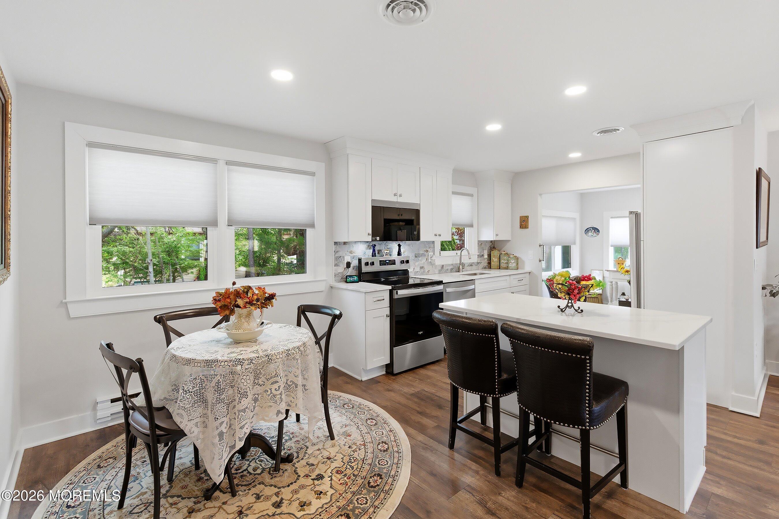 2 Berry Hill Road, Unit 72 Whiting, NJ 08759 - Photo 9 of 43 a kitchen with a dining table chairs and refrigerator