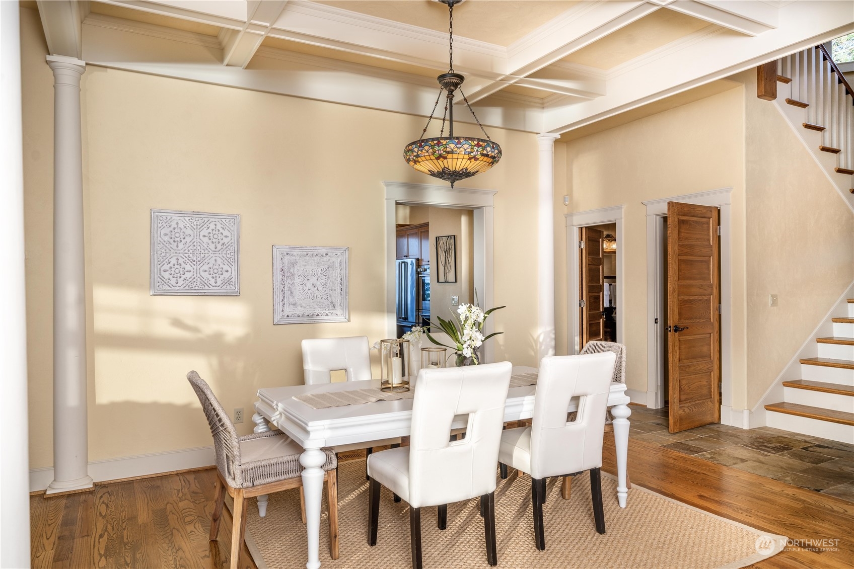 4141 Boston Harbor Road Northeast Olympia, WA 98506 - Photo 16 of 40 a dining room with wooden floor a chandelier a wooden table and chairs