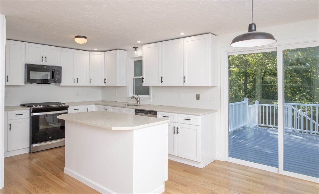 7 Warwick Way Mashpee, MA 02649 - Photo 12 of 42 a kitchen with stainless steel appliances granite countertop a stove a sink and a refrigerator