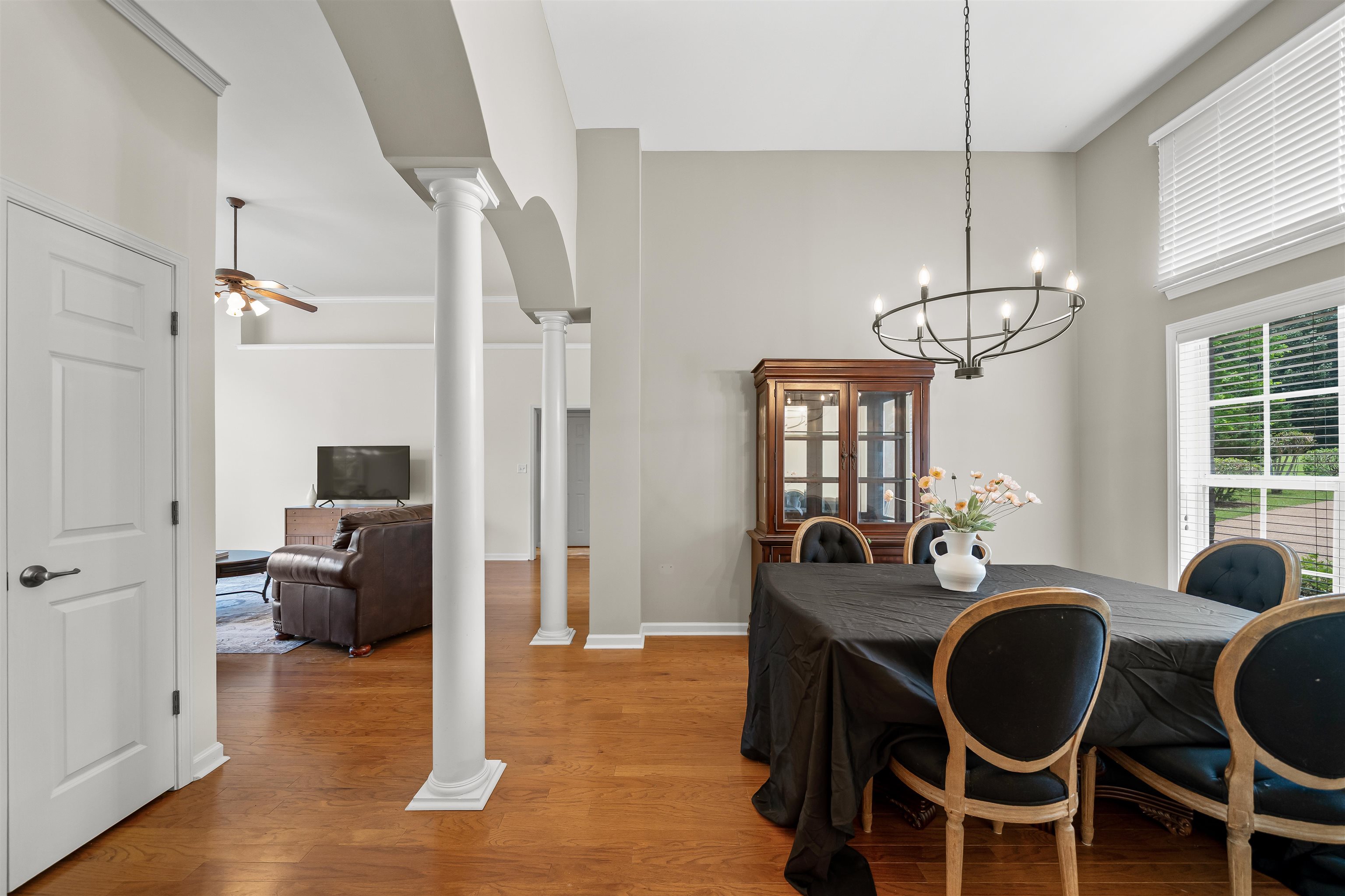 5035 Brian Ridge Road Arlington, TN 38002 - Photo 15 of 40 Dining area featuring high ceilings, wood-finish flooring, a contemporary chandelier, and large windows with integrated blinds