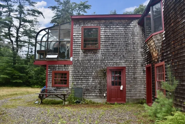 a brick building with a bench in front of house