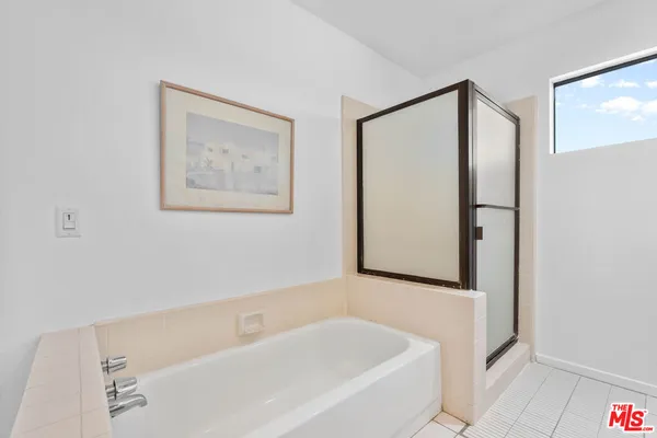 a bathroom with bathtub and shower