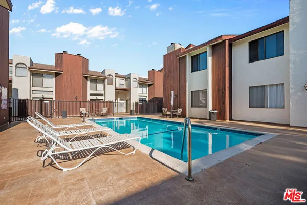 a view of a patio with a table and chairs