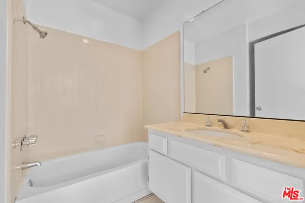 a bathroom with a tub sink and vanity