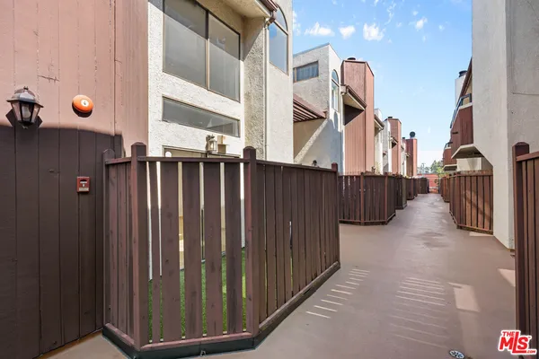 a view of a house with wooden fence