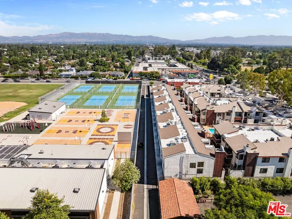 an aerial view of residential houses with outdoor space
