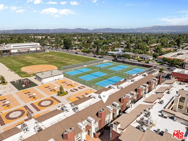 an aerial view of residential houses with outdoor space