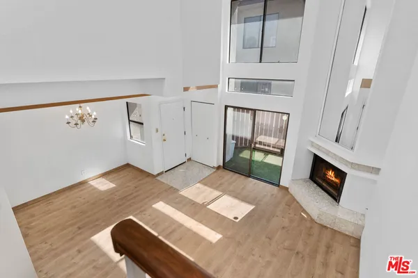 a view of a bedroom with furniture and flat screen tv