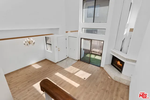 a view of a bedroom with furniture and flat screen tv