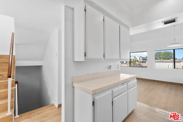 a view of a hallway to a room with stair