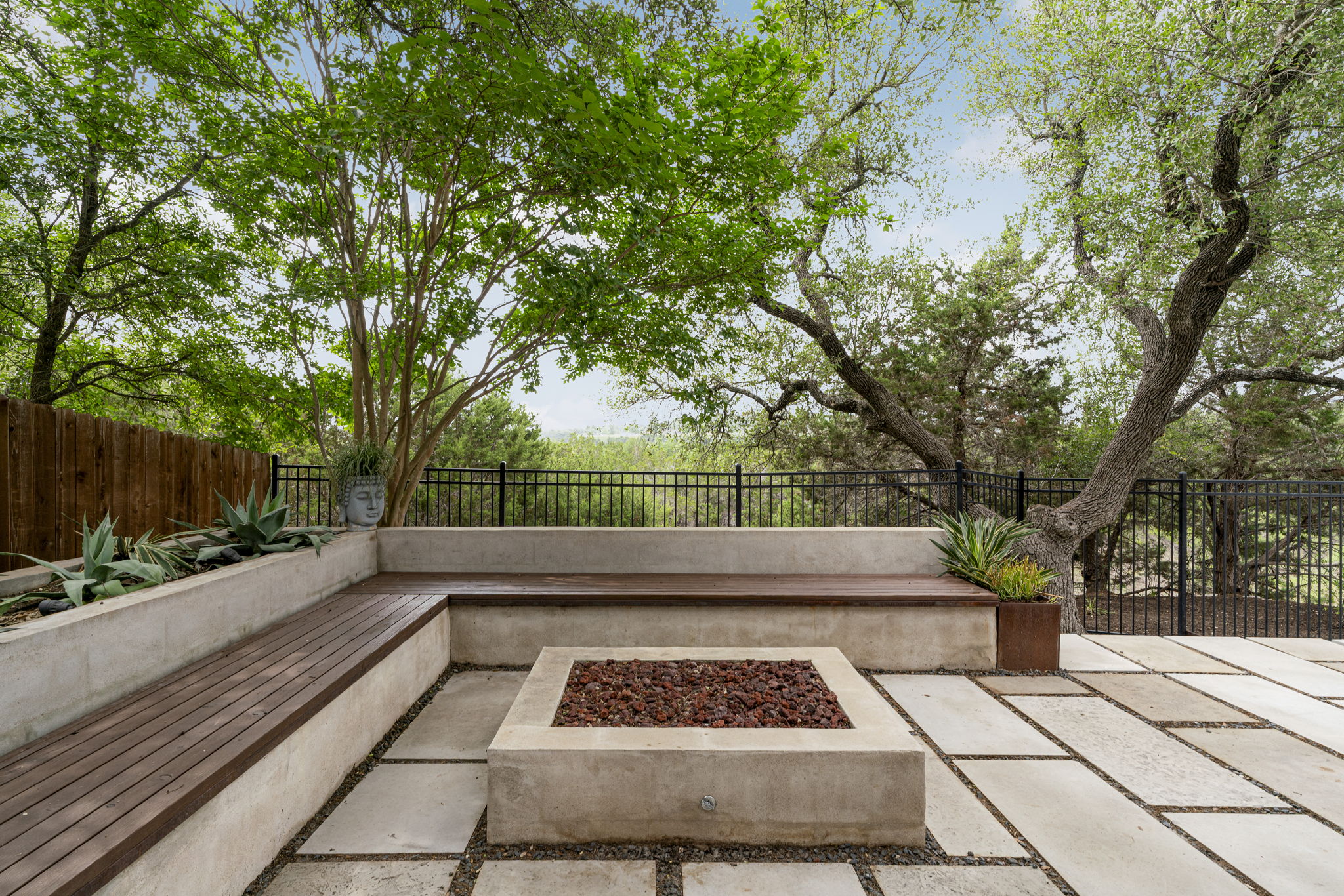 288 Hazy Hills Loop Dripping Springs, TX 78620 - Photo 36 of 40 A built-in fire pit seating area with clean lines and hidden storage, creating a true gathering space.