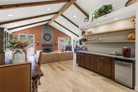 a kitchen with granite countertop a sink stove and refrigerator