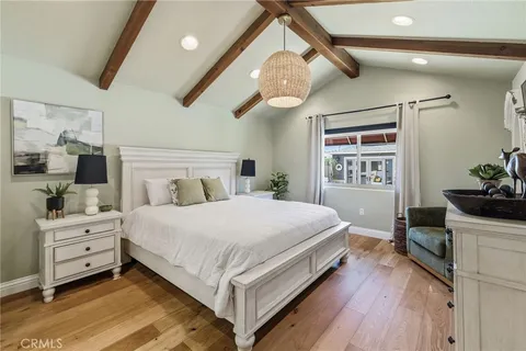 a bedroom with a bed and a mirror
