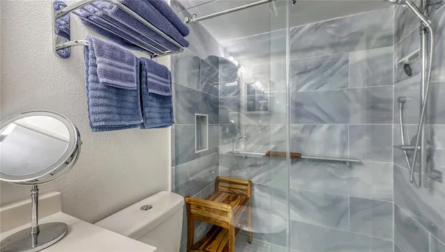 a bathroom with a toilet and a shower