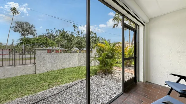 a view of a porch with a floor to ceiling window and wooden floor