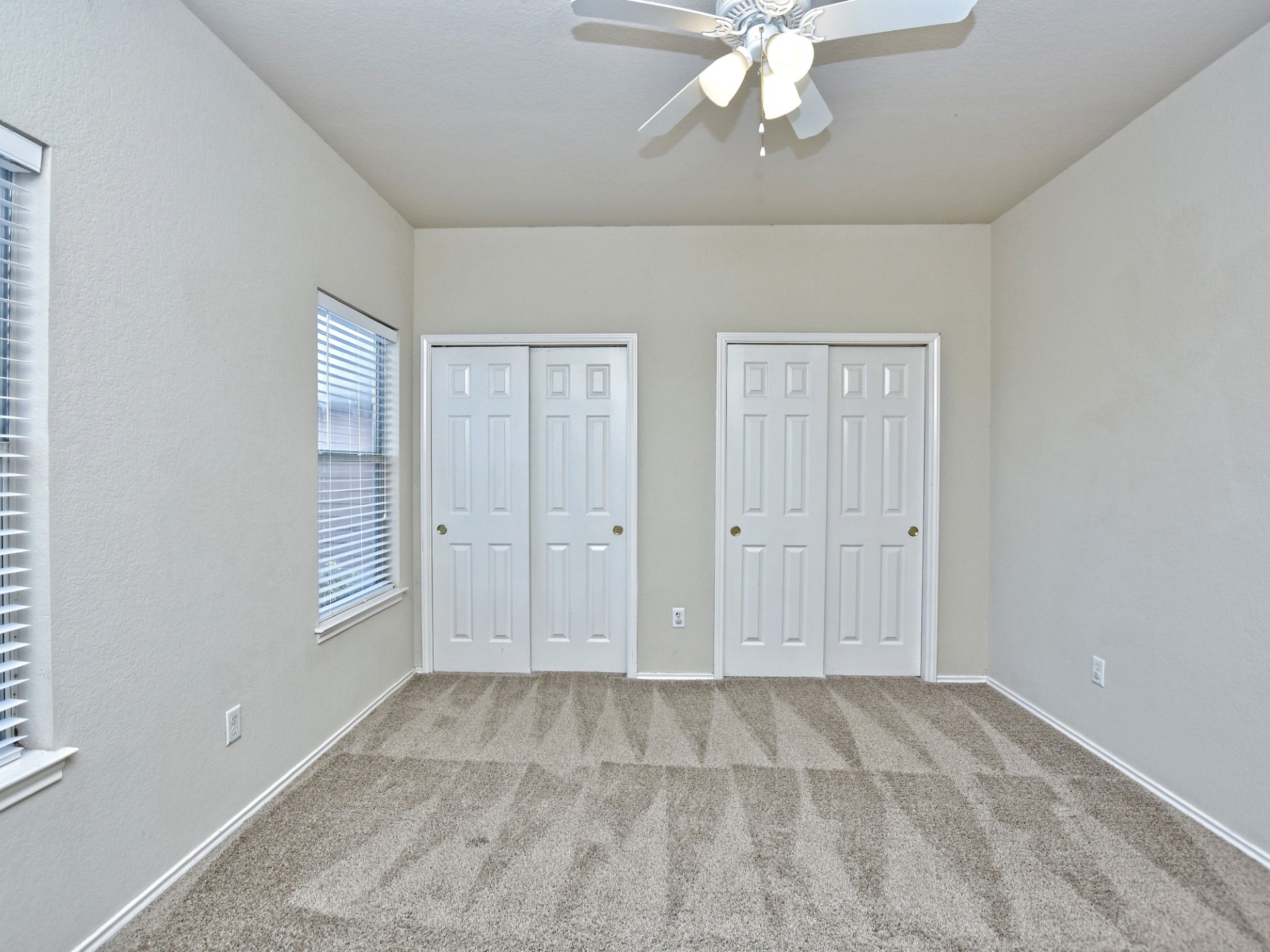 917 East 3rd Street Georgetown, TX 78626 - Photo 15 of 23 Well-lit room with practical closet space and soft carpeting for ultimate comfort.