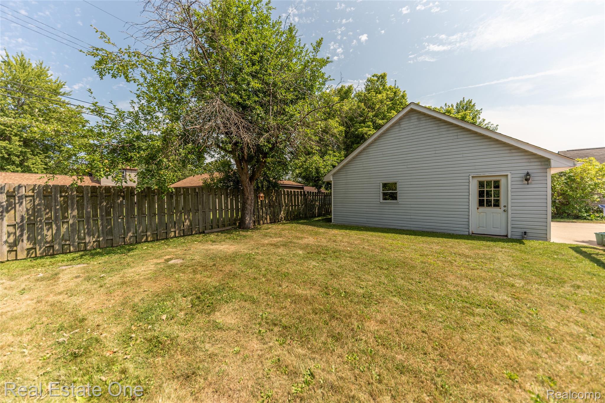 1380 North Sheldon Road Canton, MI 48187 - Photo 9 of 29 Expansive green space featuring a privacy fence, mature trees