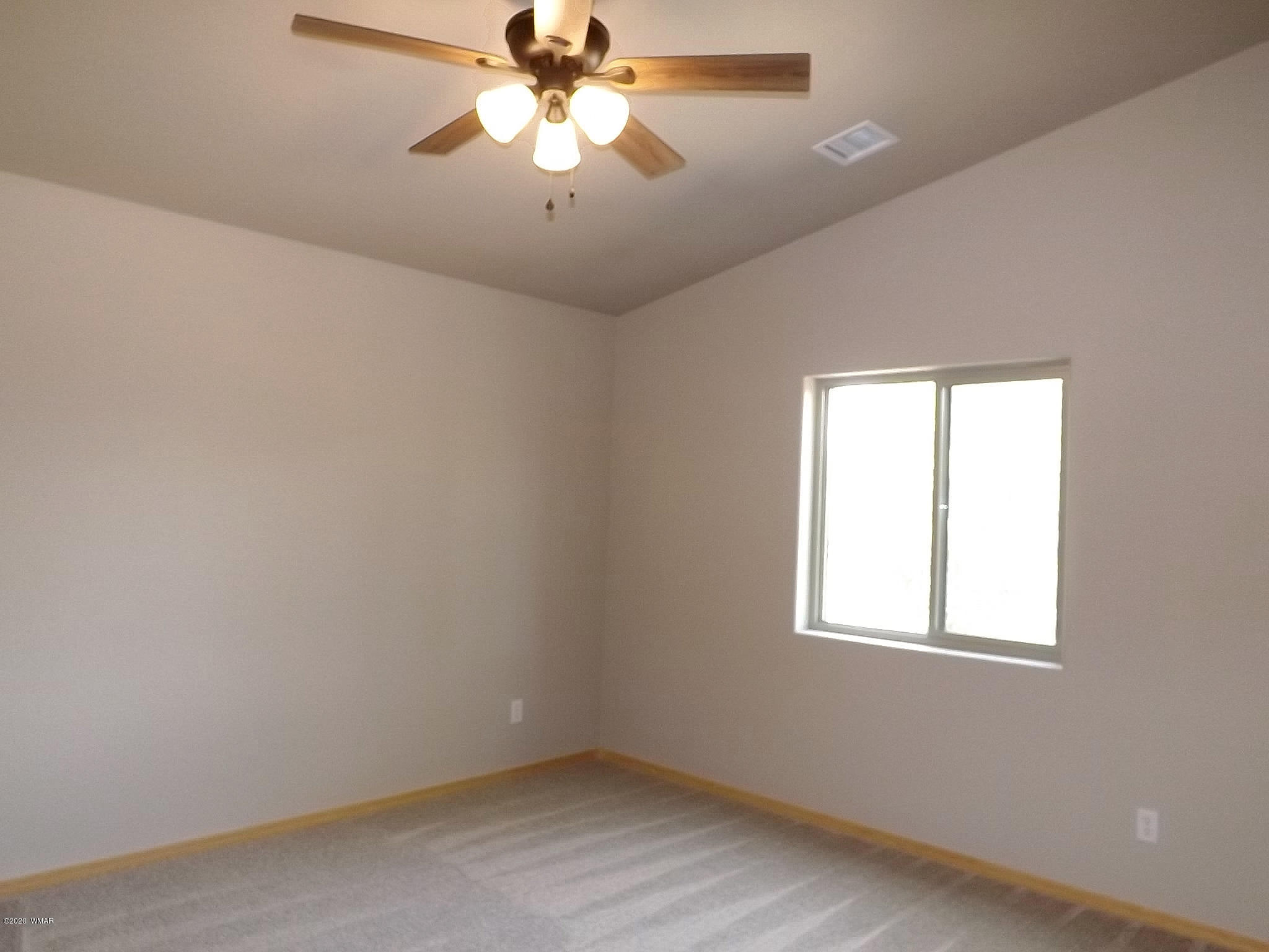3034 Aspen Road Overgaard, AZ 85933 - Photo 54 of 59 an empty room with a window and a fan
