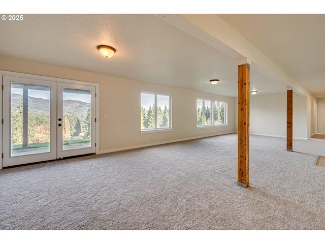 a view of a big room with windows and entryway