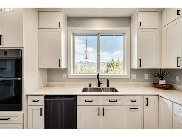 a kitchen with a sink a cabinets and window