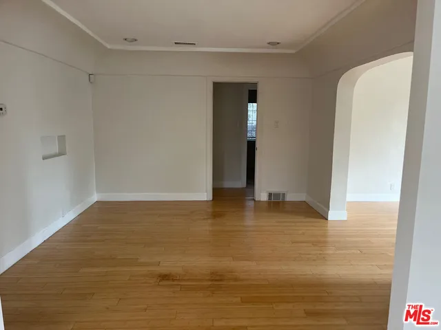 a view of an empty room with glass door