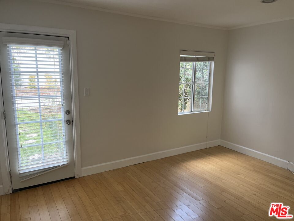101 North La Peer Drive Los Angeles, CA 90048 - Photo 27 of 33 a view of an empty room with wooden floor and a window