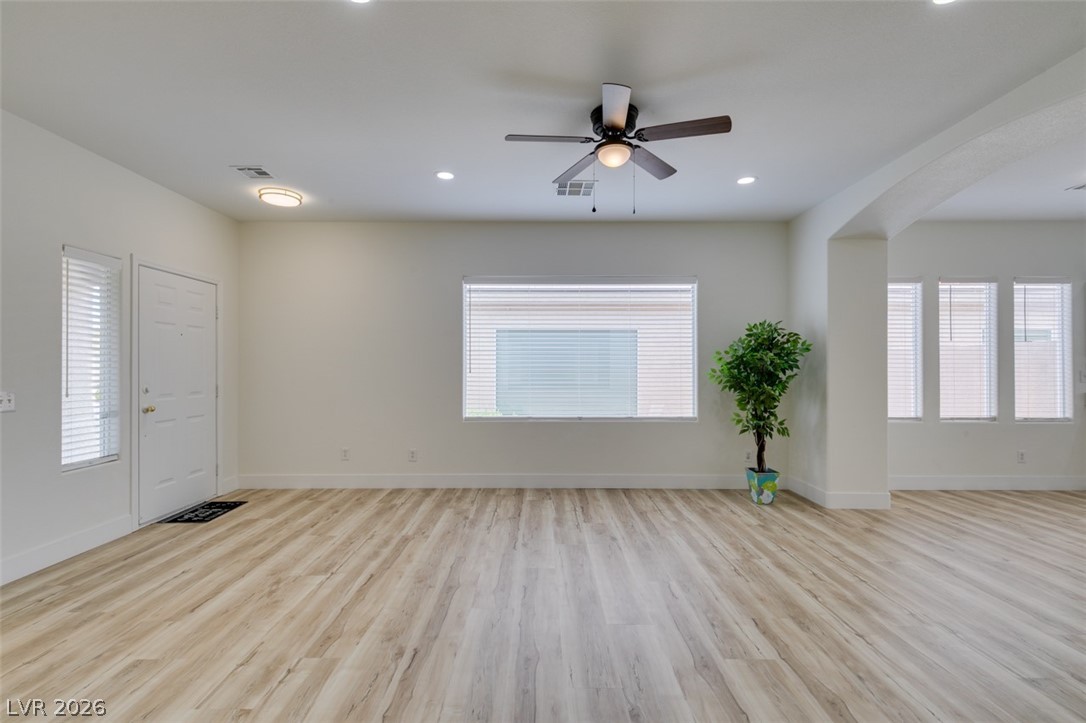 10959 Pumpkin Ridge Avenue Las Vegas, NV 89135 - Photo 6 of 51 Spacious, naturally illuminated living room features new flooring and new ceiling fan for optimal comfort.