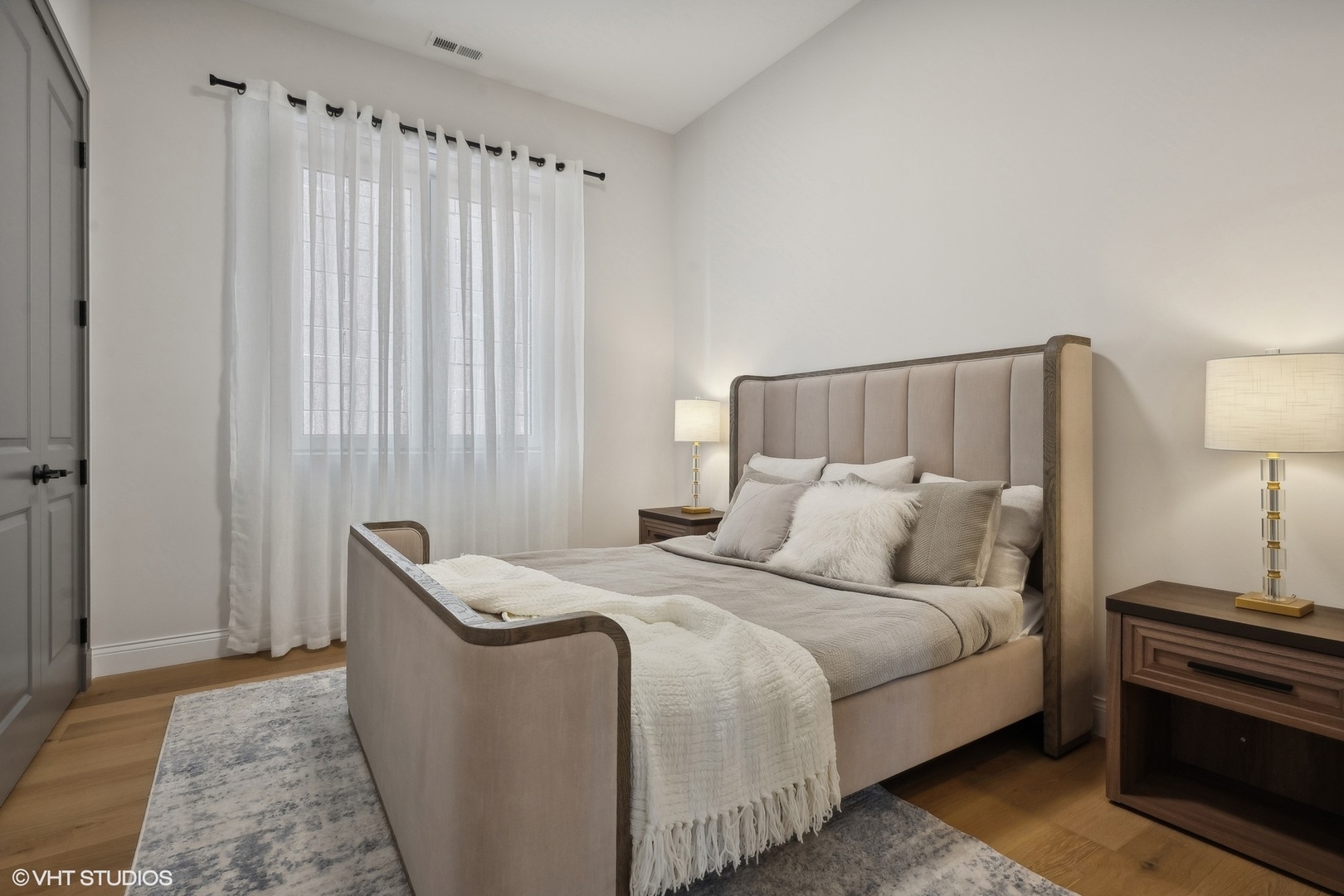 1615 West Irving Park Road, Unit 2N Chicago, IL 60613 - Photo 15 of 24 a bedroom with a bed and a night stand