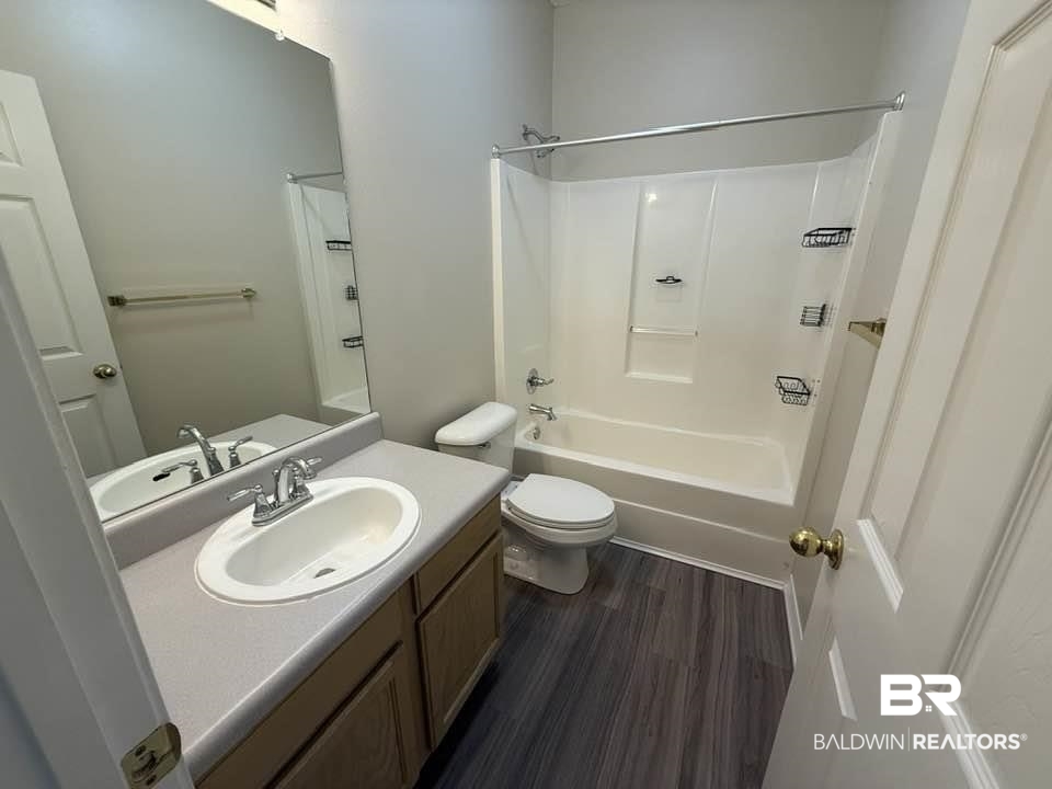 2651 South Juniper Street, Unit 401 Foley, AL 36535 - Photo 20 of 27 Bathroom with toilet, shower / washtub combination, wood finished floors, and vanity