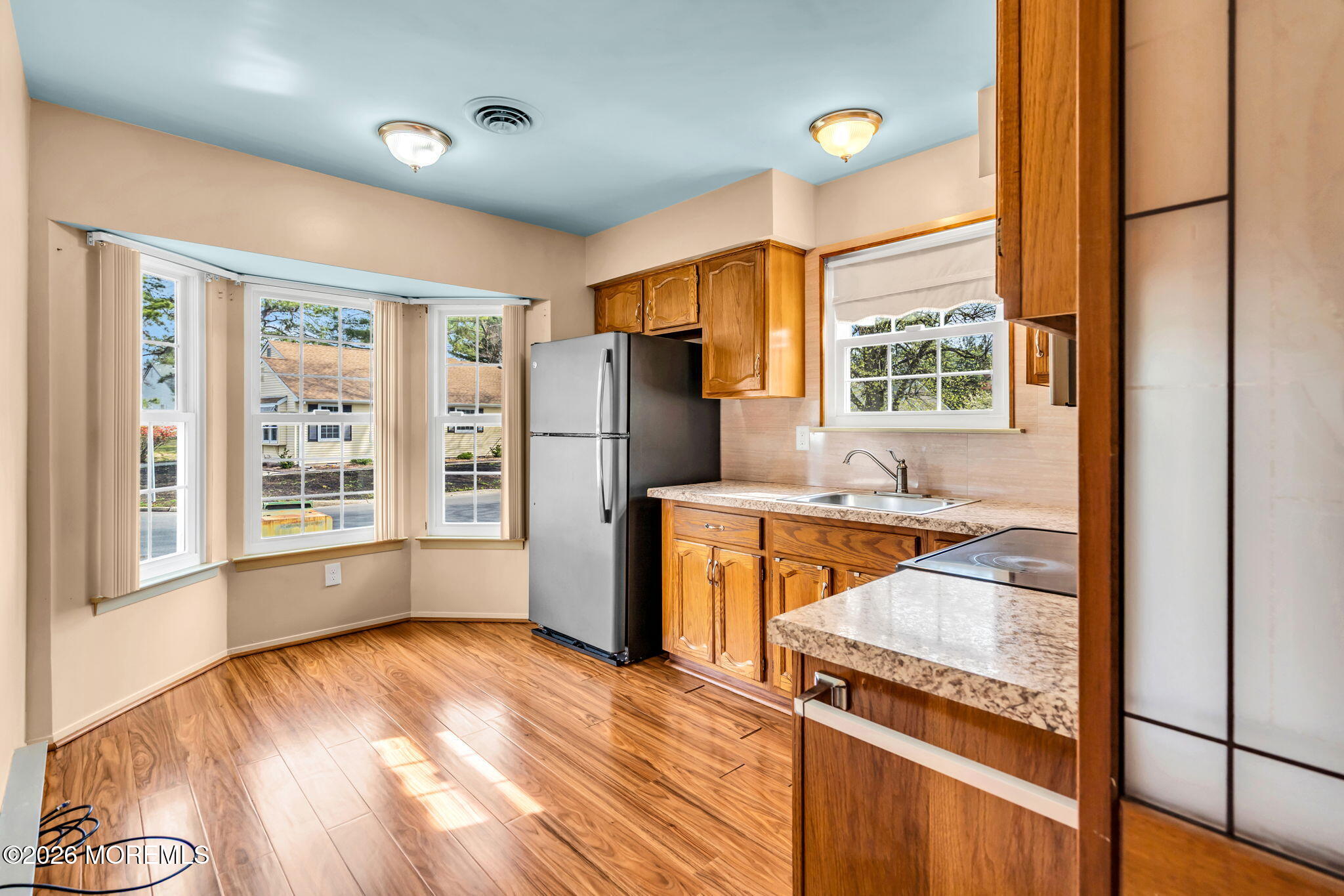 20B Amesbury Road, Unit B Whiting, NJ 08759 - Photo 7 of 25 a kitchen with granite countertop a refrigerator and a stove