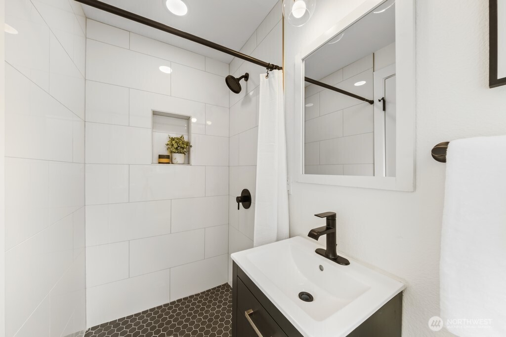 13121 Golden Given Road East Tacoma, WA 98445 - Photo 27 of 39 a bathroom with a sink a mirror and shower