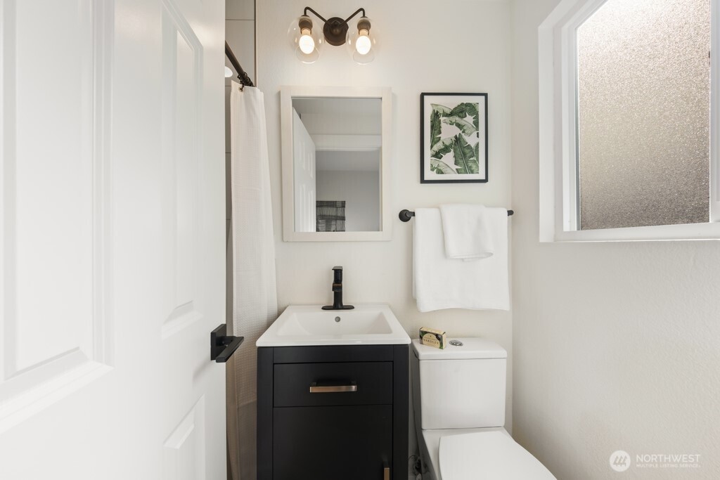 13121 Golden Given Road East Tacoma, WA 98445 - Photo 28 of 39 a bathroom with a sink toilet and vanity