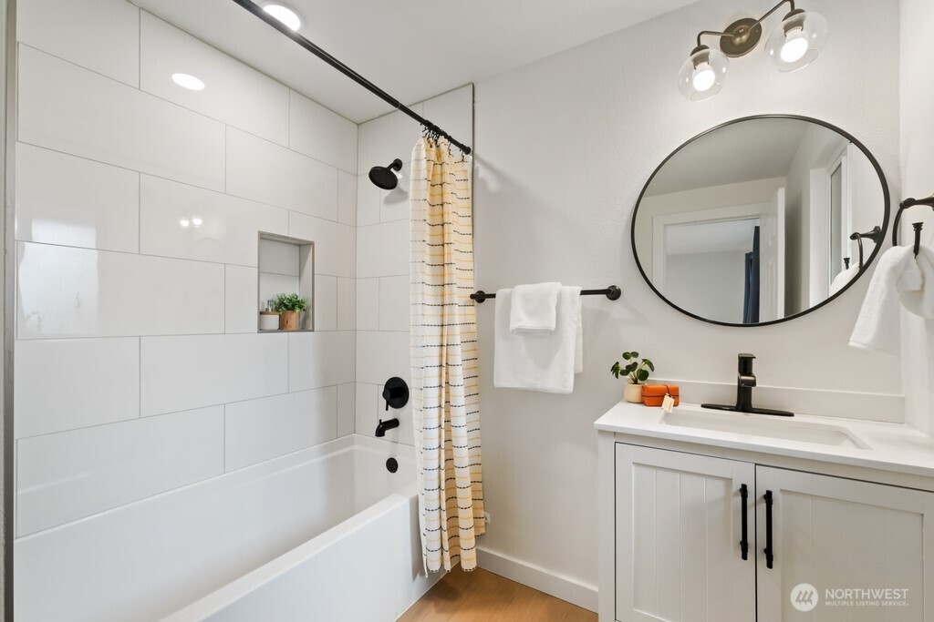 13121 Golden Given Road East Tacoma, WA 98445 - Photo 29 of 39 a bathroom with a sink a bathtub and a mirror
