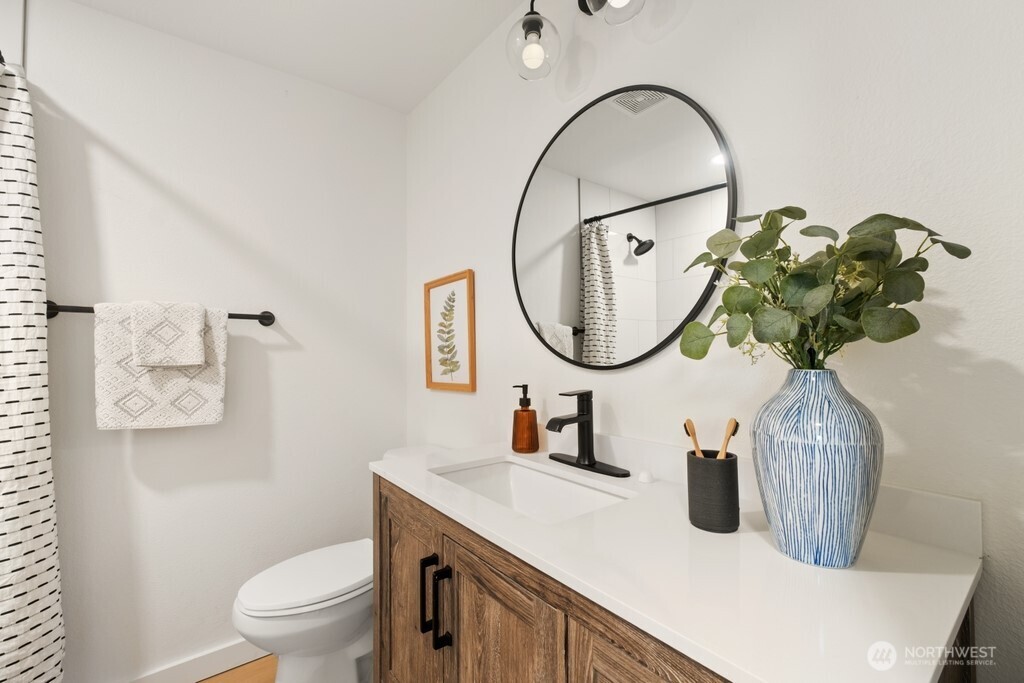 13121 Golden Given Road East Tacoma, WA 98445 - Photo 30 of 39 a bathroom with a sink a mirror and a toilet
