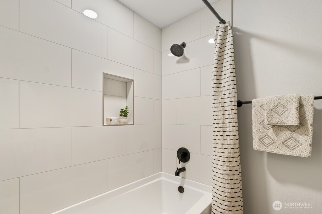 13121 Golden Given Road East Tacoma, WA 98445 - Photo 31 of 39 a bathroom with a bathtub and shower