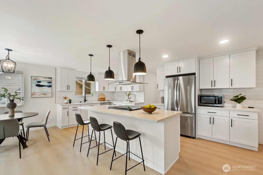 13121 Golden Given Road East Tacoma, WA 98445 - Photo 10 of 39 a kitchen with white cabinets and stainless steel appliances