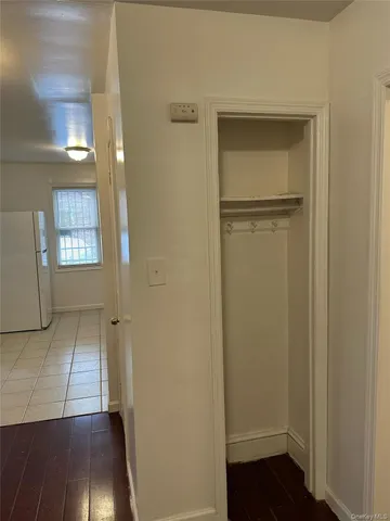 a view of empty room with wooden floor and closet