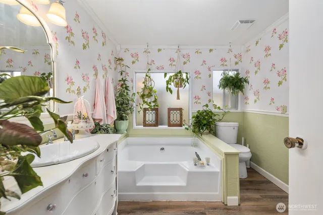a bathroom with a sink a mirror and a bathtub