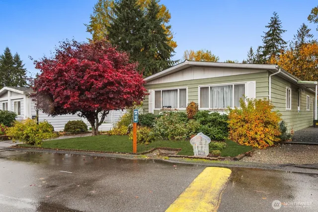 a front view of a house with a yard and potted plants