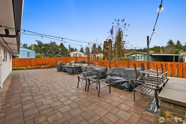 a backyard of a house with table and chairs