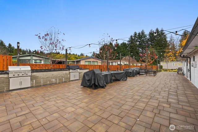 a view of a field of grass and trees