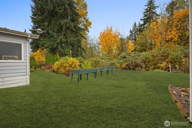 a backyard of a house with table and chairs