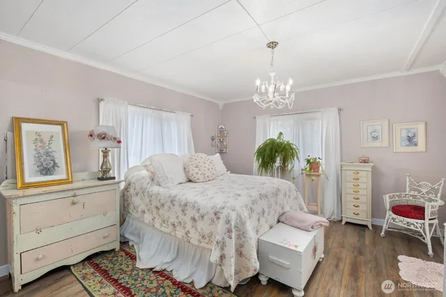 a bedroom with a bed and a chandelier